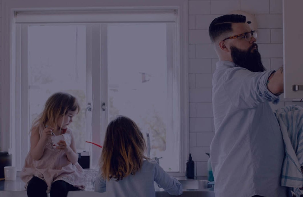 A father and his two daughters washing the dishes